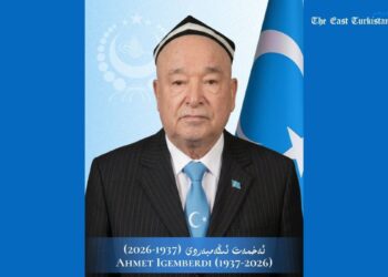 Commemorative poster honoring Ahmet Igemberdi (1937–2026); man in suit and blue tie with a Turkish flag in the background.