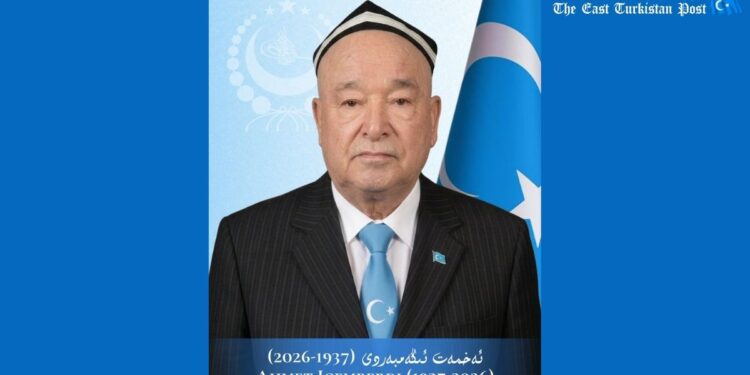 Commemorative poster honoring Ahmet Igemberdi (1937–2026); man in suit and blue tie with a Turkish flag in the background.