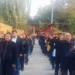 uyghur1 | Восточно-Туркестанская Почта People standing in two parallel lines outdoors, many raising their right hands to their heads in a salute during a ceremony.